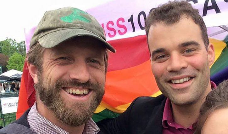 Victoria city councillors Ben Isitt and Jeremy Loveday take in the Winnipeg Pride Parade while attending the Federation of Canadian Municipalities convention
