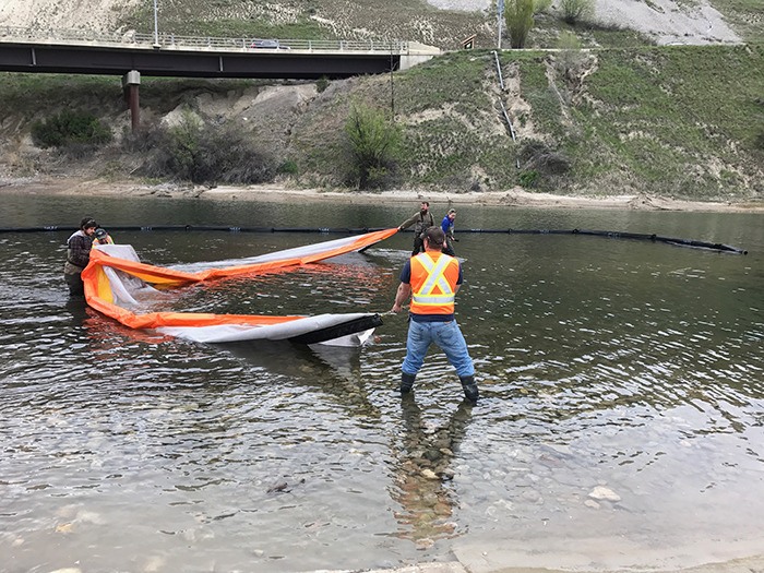 District workers install the silk curtain in front of the boat launch in Athalmer