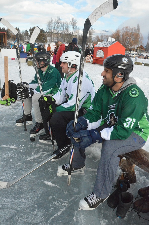 Hockey Community team players wait patiently for their turn to play in the Rockies Pond Hockey Tournament on January 31s.