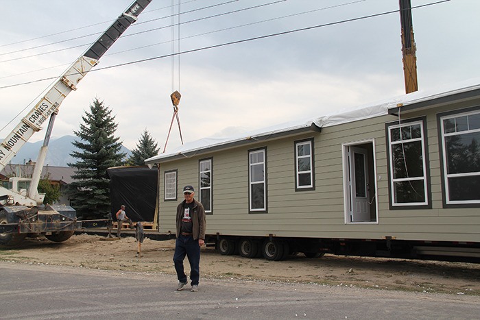 Dave Hall in front of his lot on 13th Street on Tuesday (September 25) as cranes hoist his new modular home off flatbed trucks and onto its foundation.