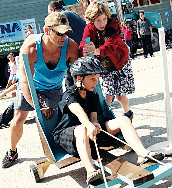 2011 — The Simpsons soap box derby team rounded the bend and headed for the finish line during a soap box derby at Valley  Appreciation Day.  The team beat out challengers in RONA built soap box cars.