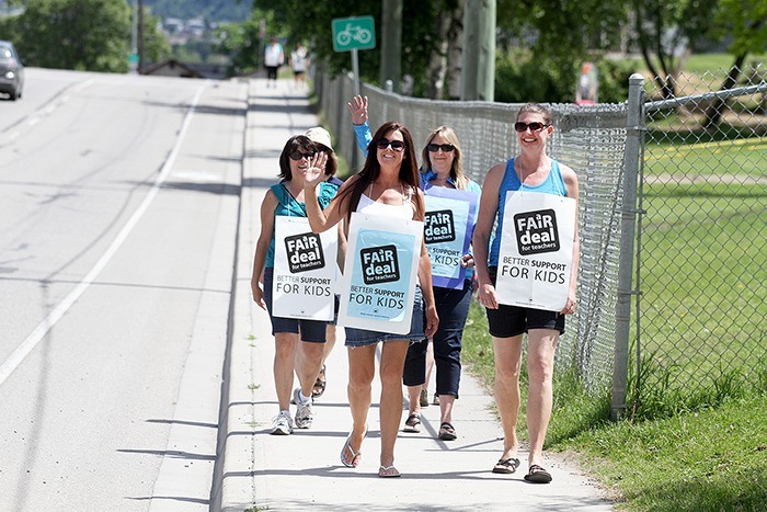 Teachers Laurel McEachnie (front left) and Kristen Dion (right) walk the picket line at Alexis Park Elementary School Wednesday with Denise Lauson (back left) and Louise Alexander.