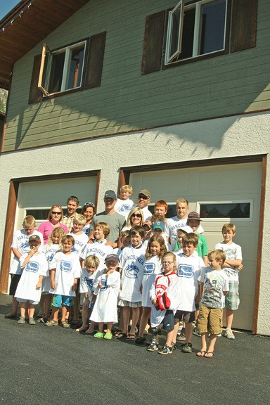 Columbia Valley skaters pose with Vancouver Canuck Mason Raymond in front of their new dry land training facility