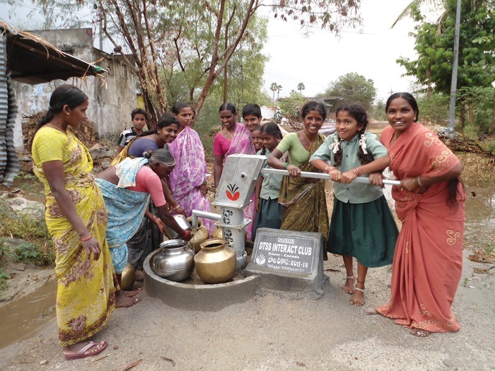 Women in the Indian village of Thimmampet are pictured operating their new bore well