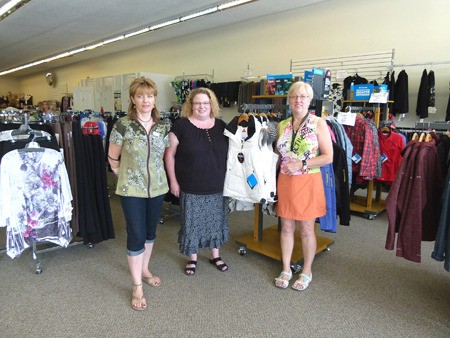 Carrie Rickards (centre) and staff stand amongst the new Columbia line display in the new Essentials Department store.