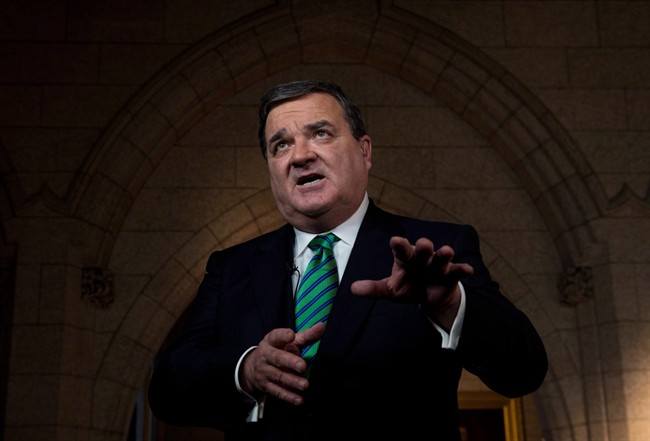 Finance Minister Jim Flaherty takes part in a TV interview on Parliament Hill in Ottawa on March 21