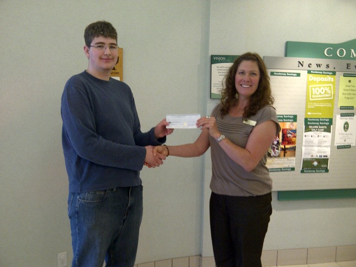 DTSS student Christopher Hynes receives $200 from CVCF co-chair Janice McGregor for designing the foundation's new logo.