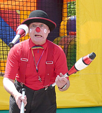 A clown entertains in the Kids Zone during Radium Days.