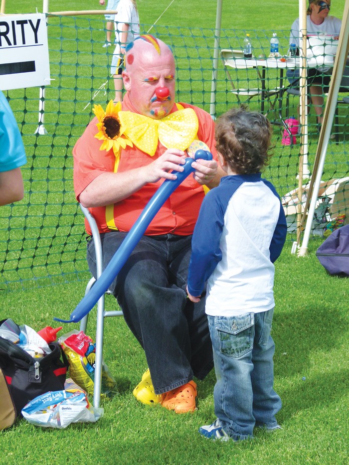 A young boy gets a balloon creation made at a past Hoodstock. The event offers activities for the whole family to go along with a great musical lineup.