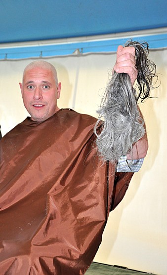 James Lazarus holds up the hair he shaved off for the Head-Shave-a-Thon.