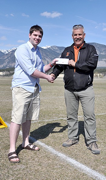 Travis Kerslake and Bighorns Head Coach Bruce Marlow. The Bighorns donated $500 each to Kerslake and Darnell Hopkins.