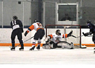 (far left) Columbia Valley Rockies' goalie Bruce Corrigal makes a tough save against the Creston Valley Thunder Cats. (Darryl Crane/echo photo