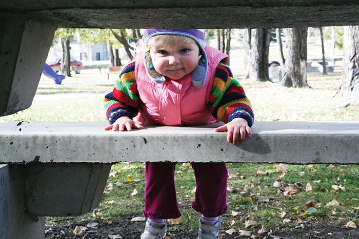October 2007 — Eighteen-month-old Megan Bell played a good game of hide and seek around the benches at Kinsmen Beach in Invermere. Bundled up in her woolliest apparel the little Invermere resident decided to scope out the fall scenery with Grandma.