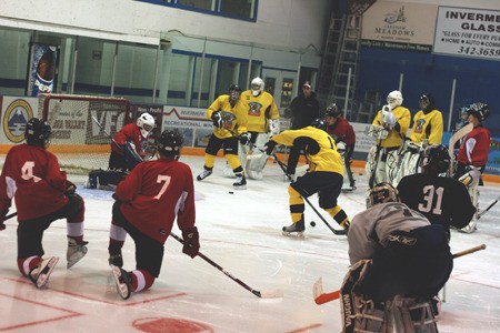 Players storm the ice at the Columbia Valley Rockies rookie camp.
