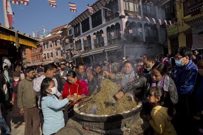 Nepalese Buddhists light incense sticks at the Boudhanath Stupa during Buddha Jayanti