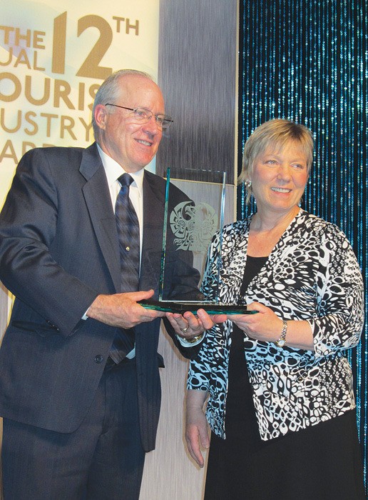 Panorama Mountain Village CEO Rick Jensen accepts B.C. Tourism's Employees First award from go2 CEO Arlene Keis. The award recognizes excellence in people management.