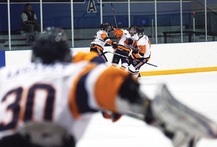 Goalie Scott Legault jumps off the bench to join his Columbia Valley Rockies teammates in post-game celebrations after an overtime win over the Spokane Braves January 13