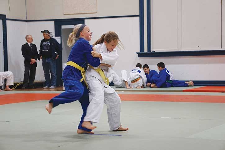 The Invermere Judo Club had an impressive showing at a tournament in Creston earlier this month. Marnie Rainbow (in white) applies a tai otoshi (side body drop) as Cassia Riches resists.