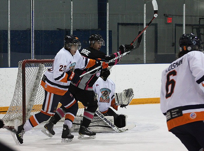 Rockies rookie Jake Farode battles with a Fernie skater in front of the Rockies net during the first period of the Rockies 7-6 comeback victory on Tuesday