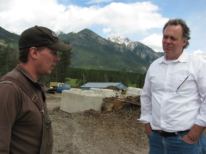 Norm Macdonald (right) recently toured the empty wood holding area at Edgewater's WoodEx mill.