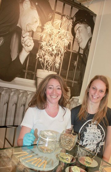Nelson Potorium owner Chris Campbell and her employee Kaleigh Herald pose with some of the products they sell from their Baker Street storefront.