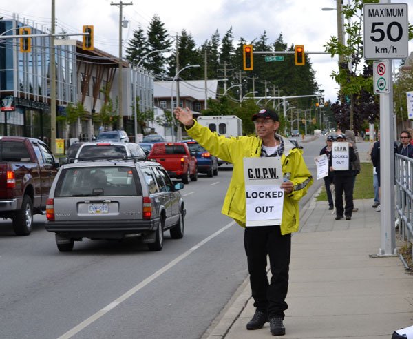 Postal workers picket at a South Surrey office Wednesday.