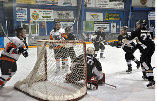 Players from the Columbia Valley Rockies and Grand Forks Border Bruins all are keeping a close eye on the puck and the Bruins' goalie is not sure where it has gone. The Rockies won their last game of the season 5-1 against the Bruins in a fight filled affair at the Eddie Mountain Memorial Arena in Invermere on February 12.  DArryl Crane/echo photo