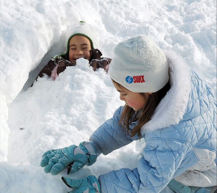 2009 — A pair of youngsters enjoy playing in the snow during the annual Bonspiel on the Lake