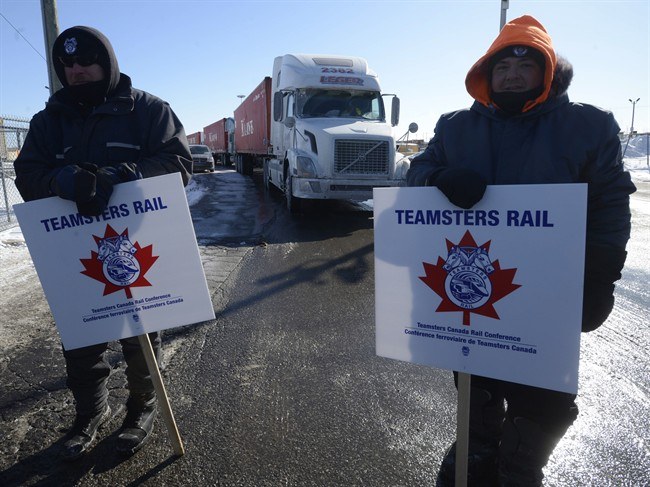 Canadian Pacific Railway workers walk the picket line while on strike at the Cote Saint-Luc railyard in Montreal on Monday