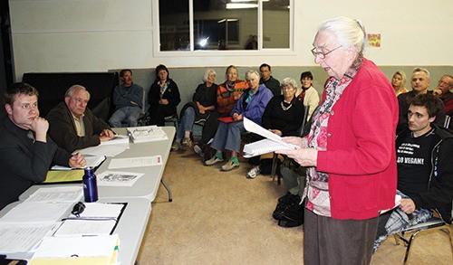 Hedi Trescher of the Windermere District Farmers Institute reads the final statement of the night at the zoning amendment public hearing for a proposed abattoir slated for Invermere's crossroads with Highway 93/95. More than 170 people packed the Windermere Community Hall for the April 24th meeting.