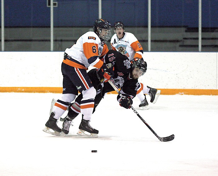 Rockies defenceman Brandon Lijdsman lays a big hit on Fernie forward Andrew White during the Rockies 8-5 loss Saturday November 19.