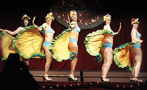 Performers from the Cheesecake Burlesque Revue troupe on-stage.