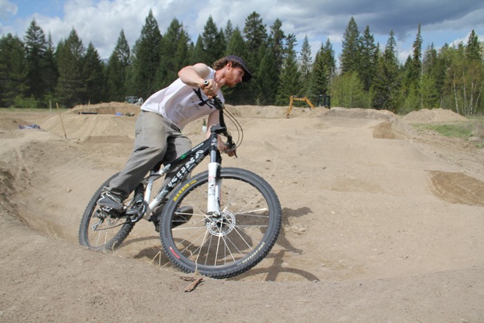Panorama resident and Columbia Valley Cycling Association trail building crew member Owen Peters tries out the new pump track in Radium Hot Springs on Wednesday