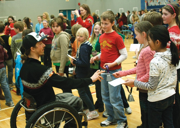 Canadian Para-Alpine ski team member Josh Dueck signs autographs for students at J.A. Laird Elementary School February 20. Dueck and his team will compete at Panorama March 13 to 16 in the IPC Alpine Skiing World Cup Finals.