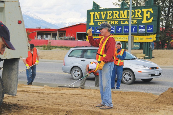 Rotary Crossroads project co-ordinator Rod Turnbull directs a top soil delivery to the intersection of Athalmer Road and Highway 93/95 on Wednesday