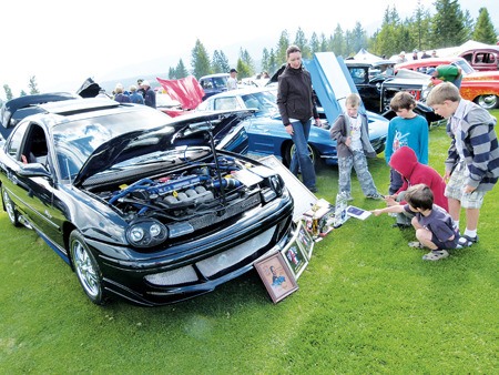 Young Show and Shine goers check out a choice vehicle on display.