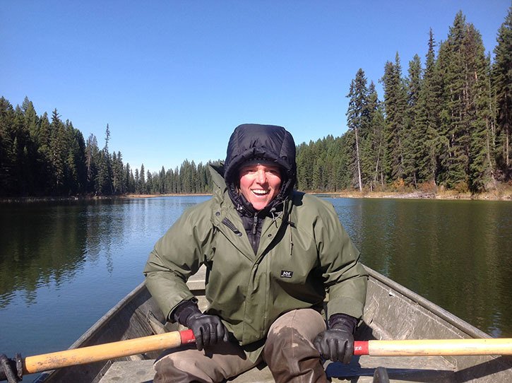 Fisheries biologist Heather Lamon rows her boat ashore on Whiteswan Lake.