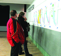 Guests at the January 2011 Lake Windermere Management Plan meeting inspect revised zoning maps.
