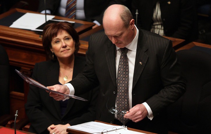 Premier Christy Clark listens as Finance Minister Mike de Jong delivers his third budget speech in the B.C. legislature