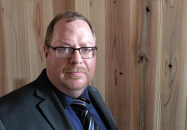 Nechako Lumber CEO Alan Fitzpatrick tours a cross-laminated timber test house at Building Research Institute