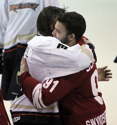 Rebels' Erik Wentzel and Coyotes' Stefan Jensen share a moment while the teams shake hands at the end of Game 6 of the KIJHL championship. The Osoyoos Coyotes won the game 7-1 and the series 4-2.