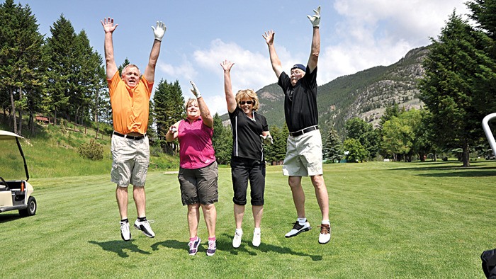 Participants leap for joy in last year's Giving Back Golf Tournament event