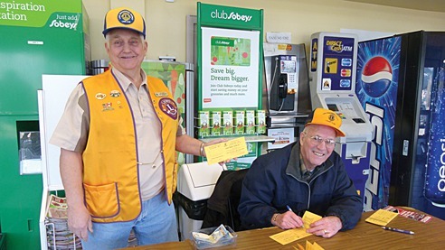 Lake Windermere District Lions Club members Leo Kienitz (l) and Al Lynch sell Ice Out tickets  in Invermere's Sobeys. Tickets are also available to purchase at AG Valley Foods and Home Hardware.
