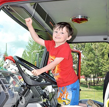 A boy enjoys a ride in the fire trucks on display during 2010's Radium Days.