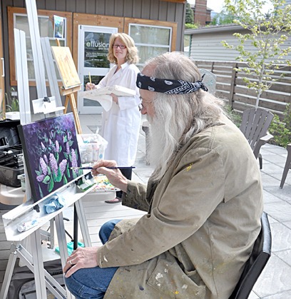 Murray Phillips and Carmel Clare paint outside effusion art gallery in Invermere