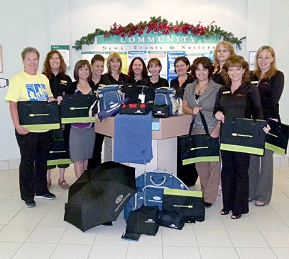 Sheila Tutty and the Kootenay Savings Credit Union staff with the donated Relay prizes.