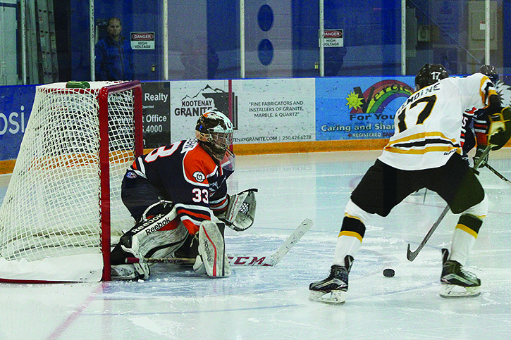 Rockies' goaltender Will McCreight protects the net against a Border Bruins player.