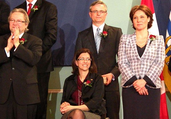 Premier Christy Clark unveils her first cabinet lineup in March. Barry Penner (background) resigned as attorney general in August