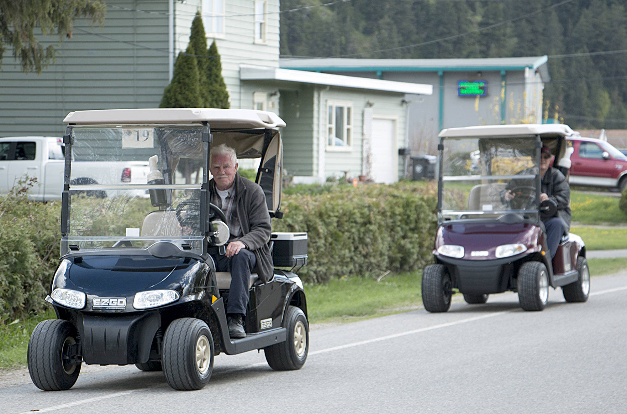 Rick Koch photo.                                Soon you will be seeing a lot more golf carts on the roads. Former Chase Mayor Ron Anderson rides a golf cart back to Sunshore Golf Course.