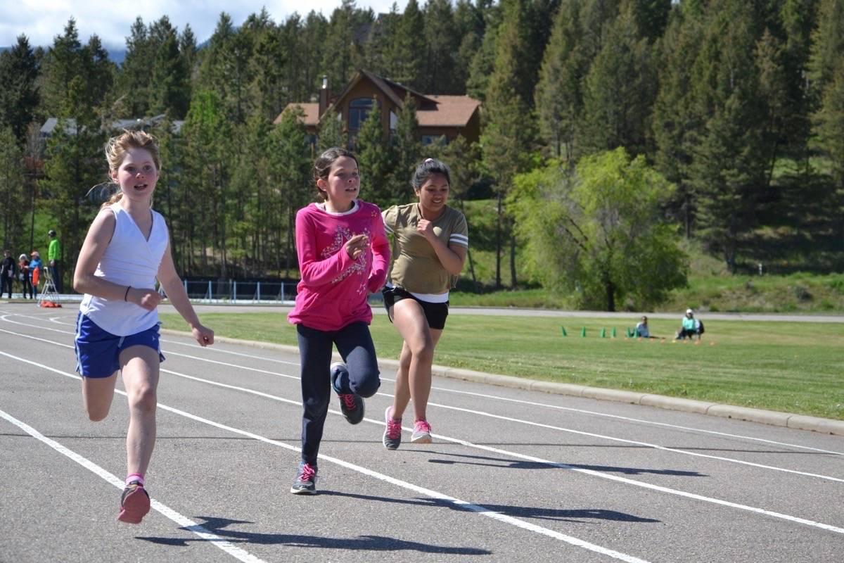 Harley Chemelli, Margeurite Blanchard, Amber Fadri focus on the race during Windermere Elementary’s track and field day.                                Photos by Nikki Fredrickson